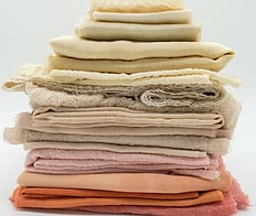 pile of folded natural fabrics