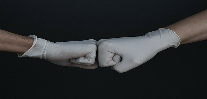 two hands wearing disposable gloves