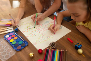 Children drawing and creating Christmas cards