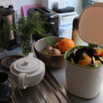 Indoor composter on kitchen counter filled with food scraps