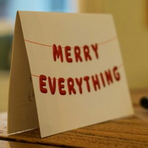 Cover of a handmade eco-friendly Christmas card with the words Merry Everything in red