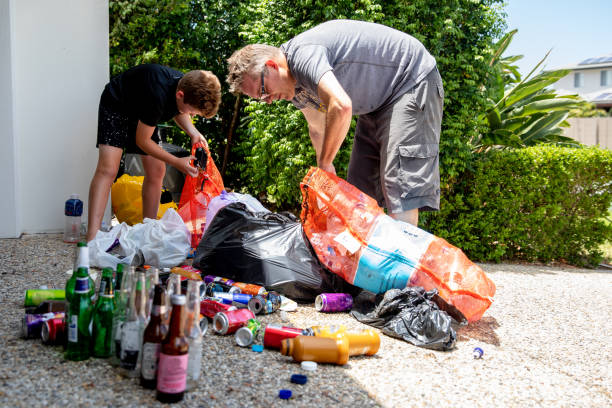 Youth and Adult recycle bottles and cans for a sustainable future