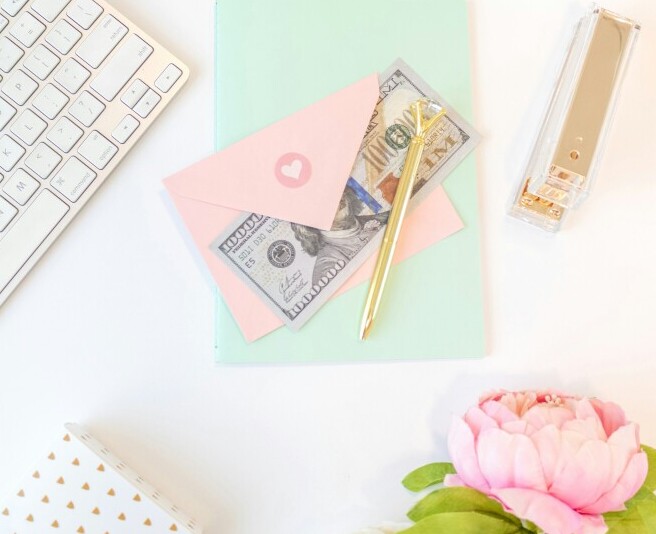 items on a desk. keyboard, stationery, stapler and $$$