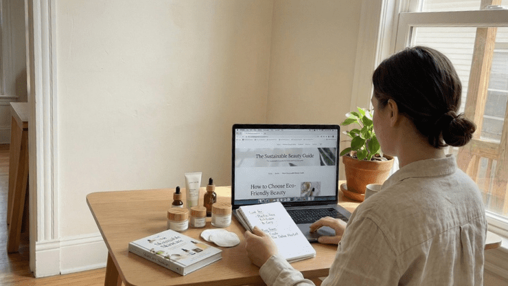 Lady sitting at desk searching laptop for beauty products online