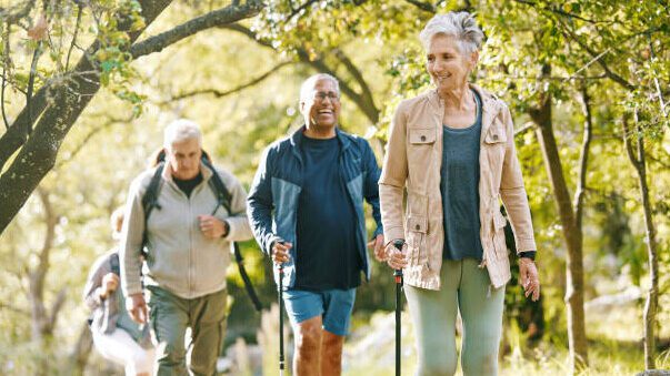 Group of older people walking in natural environment