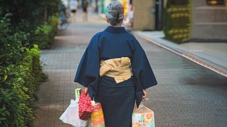 Japanese person walking holding bags